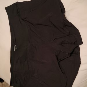 Women's athletic shorts, black in color, polyester fabric, inside liner.